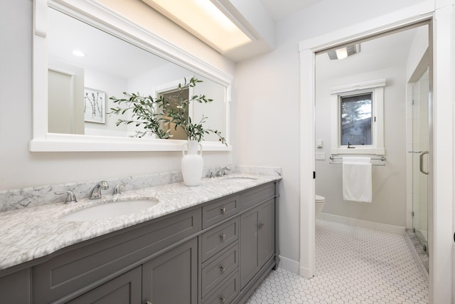 bathroom featuring tile patterned floors, vanity, toilet, and walk in shower