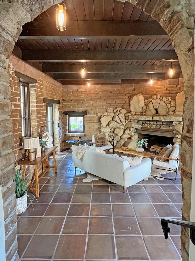 unfurnished living room with beam ceiling, dark tile patterned floors, and wood ceiling