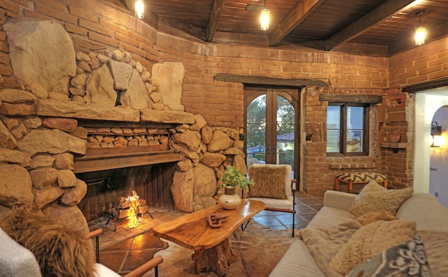 tiled living room with beam ceiling, french doors, a stone fireplace, brick wall, and wood ceiling