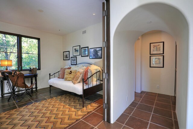 corridor with dark tile patterned flooring