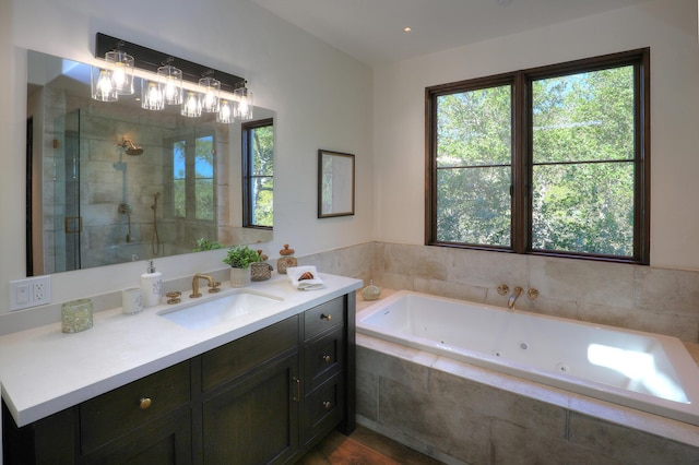 bathroom featuring separate shower and tub and vanity