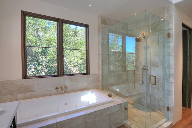 bathroom featuring separate shower and tub, hardwood / wood-style floors, and vanity