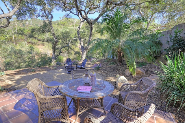 view of patio / terrace featuring a mountain view and an outdoor fire pit