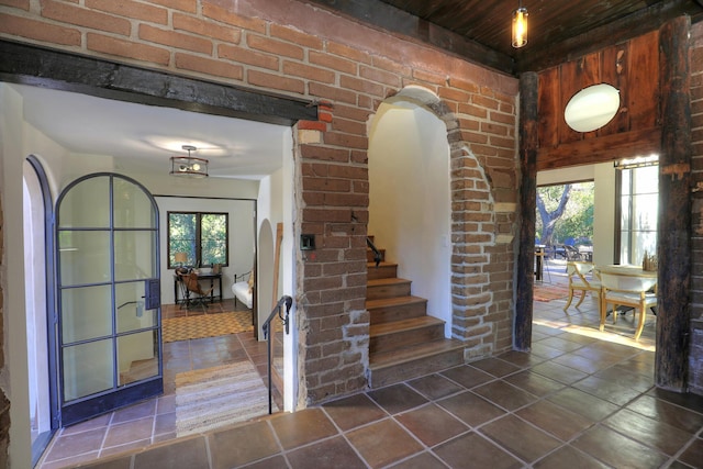 foyer with plenty of natural light and wooden ceiling