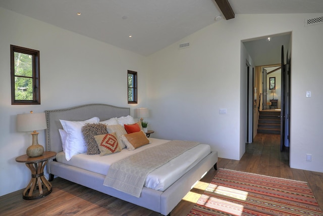 bedroom featuring vaulted ceiling with beams and dark hardwood / wood-style floors