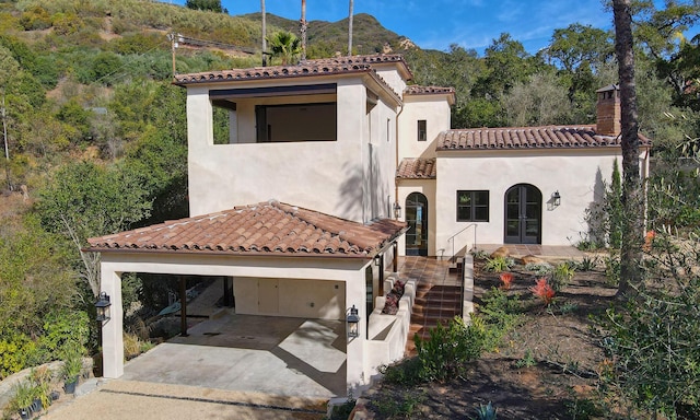 mediterranean / spanish-style home featuring a mountain view and a garage