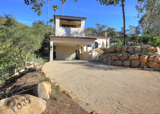 view of side of property with a carport