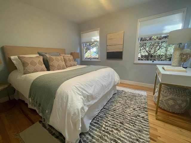 bedroom with hardwood / wood-style flooring