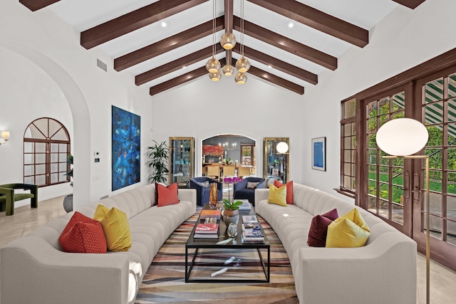 living room featuring beam ceiling, french doors, high vaulted ceiling, a notable chandelier, and light tile patterned flooring