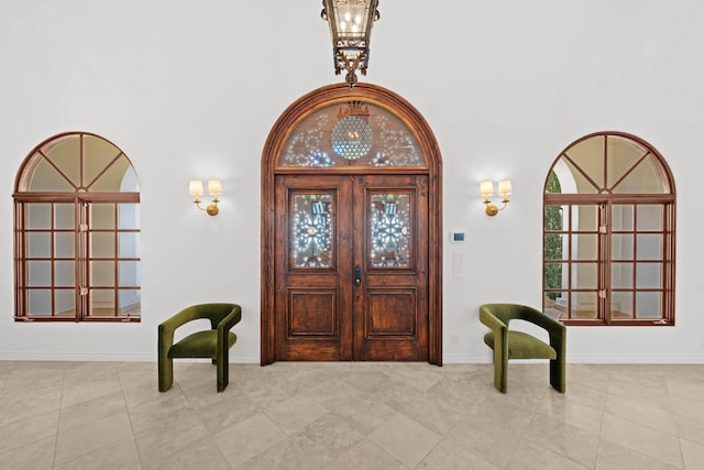 entryway featuring french doors and light tile patterned floors