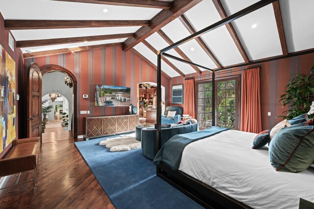 bedroom featuring vaulted ceiling with beams and hardwood / wood-style flooring