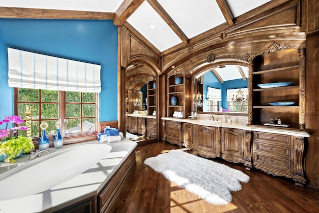 bathroom with a tub, vaulted ceiling with beams, vanity, and wood-type flooring