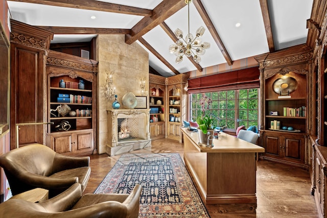 office area with a chandelier, lofted ceiling with beams, light hardwood / wood-style floors, and a tiled fireplace