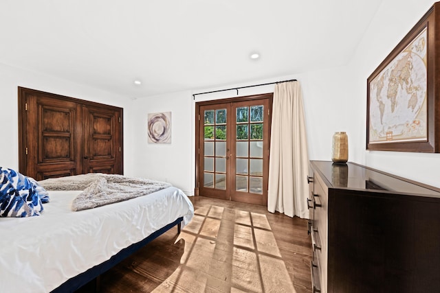 bedroom with access to exterior, light wood-type flooring, and french doors