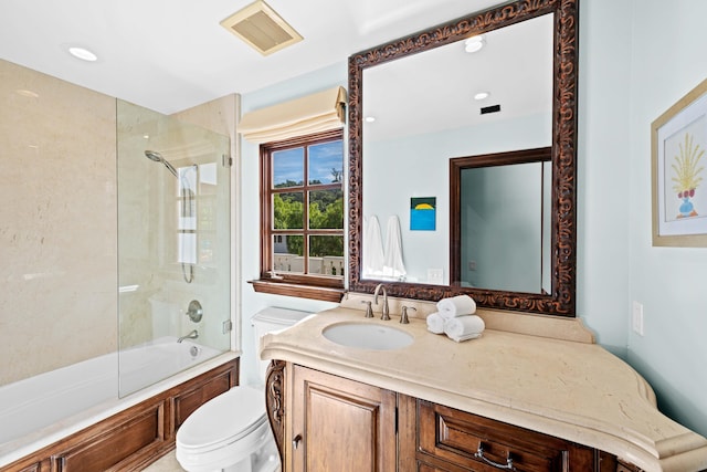 full bathroom featuring vanity, toilet, and bath / shower combo with glass door