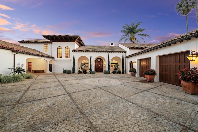 mediterranean / spanish house featuring a garage