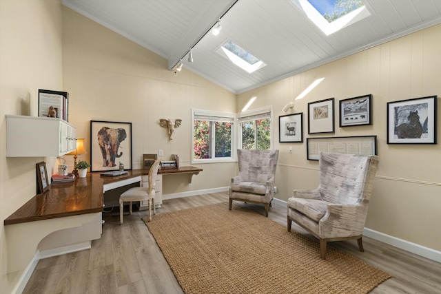 home office featuring ornamental molding, track lighting, light hardwood / wood-style flooring, and lofted ceiling