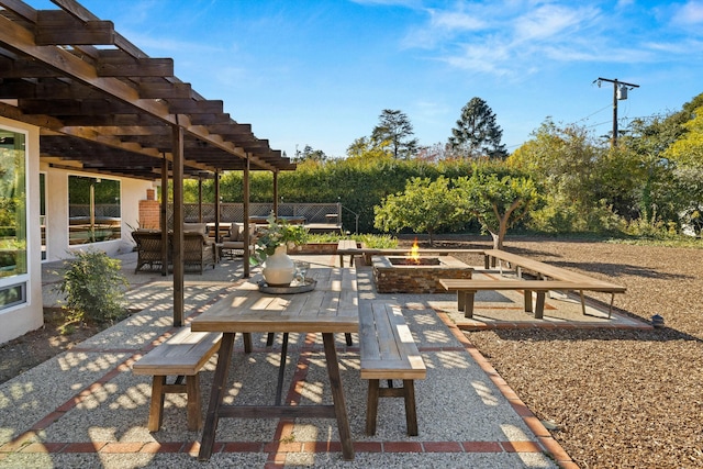 view of patio / terrace with a pergola and an outdoor living space with a fire pit