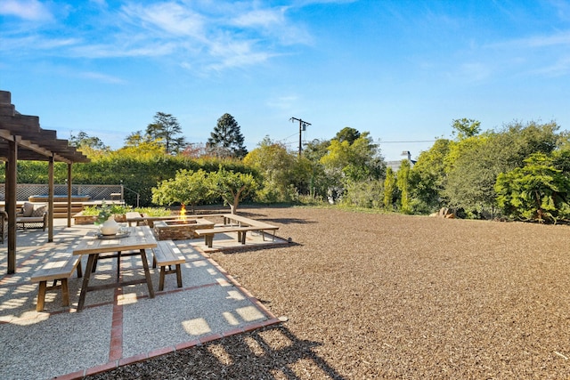 view of property's community with a fire pit, a patio area, and a pergola