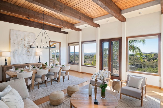 living room featuring wooden ceiling, a chandelier, beam ceiling, and light hardwood / wood-style flooring