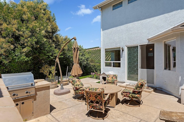 view of patio / terrace featuring outdoor dining area, fence, grilling area, and area for grilling