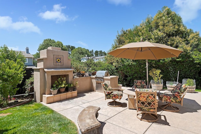 view of patio / terrace featuring area for grilling and an outdoor fireplace