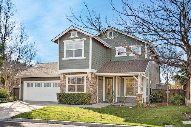 craftsman house featuring concrete driveway, stone siding, roof with shingles, an attached garage, and a front yard