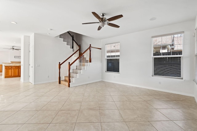 empty room with light tile patterned floors, baseboards, ceiling fan, stairway, and recessed lighting