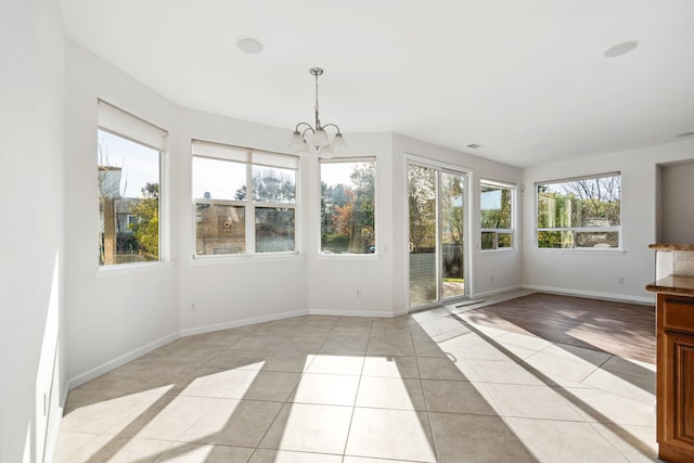 unfurnished sunroom with a chandelier