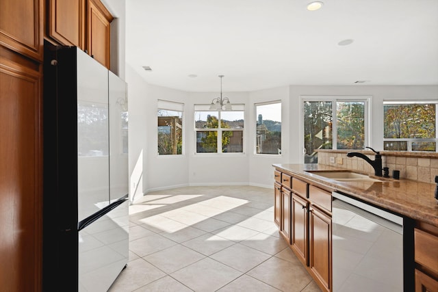 kitchen featuring a sink, a wealth of natural light, pendant lighting, and stainless steel dishwasher