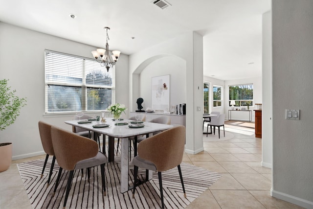 dining space with visible vents, a notable chandelier, baseboards, and light tile patterned flooring