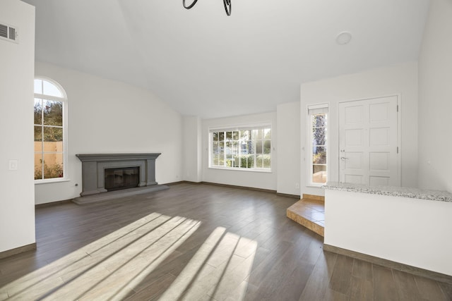 unfurnished living room featuring dark hardwood / wood-style flooring and lofted ceiling