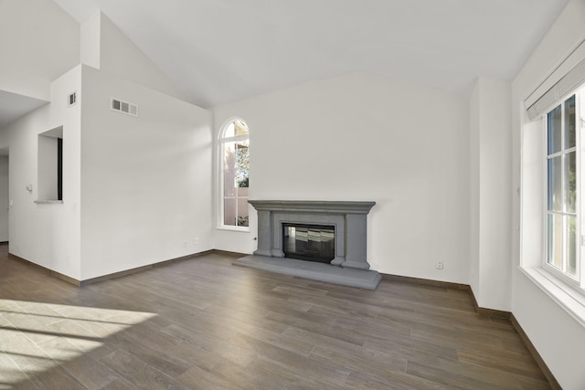 unfurnished living room with dark wood-type flooring and lofted ceiling