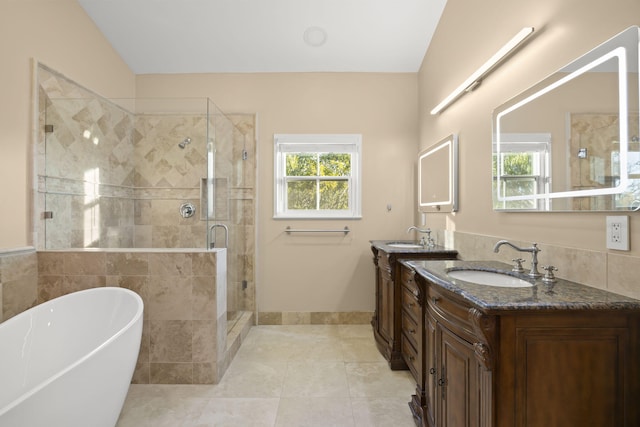 bathroom with tile patterned floors, vanity, lofted ceiling, and shower with separate bathtub