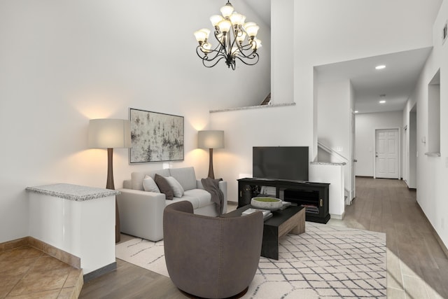 living room with light hardwood / wood-style flooring and a notable chandelier