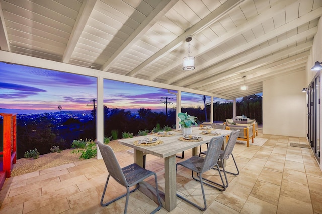 patio terrace at dusk featuring a fire pit