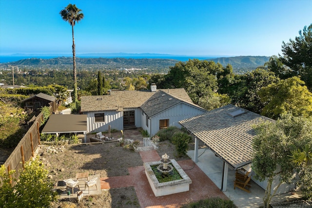 birds eye view of property with a mountain view