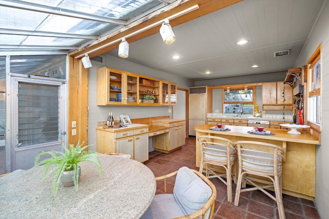 kitchen with light brown cabinets, butcher block countertops, and white dishwasher