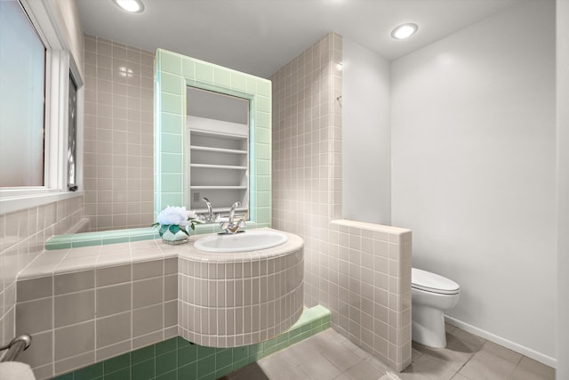 bathroom featuring toilet, a shower, and tile patterned floors