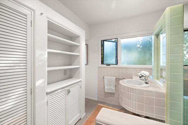 bathroom featuring tile patterned flooring and tile walls