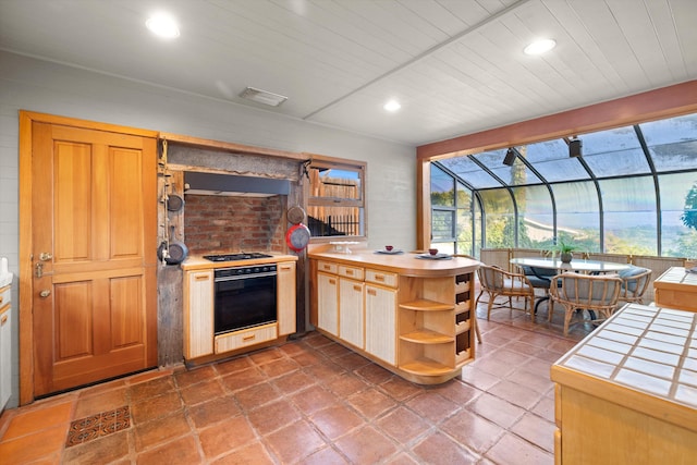 kitchen with tile countertops, stove, kitchen peninsula, and wood ceiling