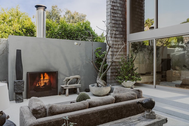 view of patio featuring exterior fireplace