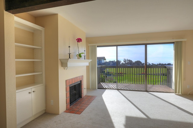 living room featuring a fireplace, carpet flooring, and built in features