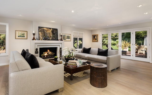 living room with light wood-type flooring and french doors