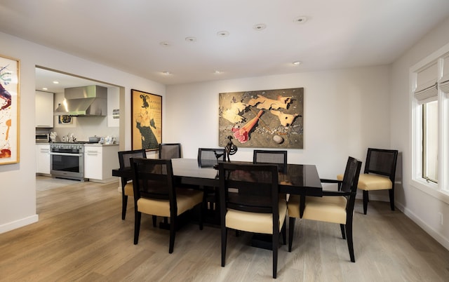 dining space with light hardwood / wood-style floors