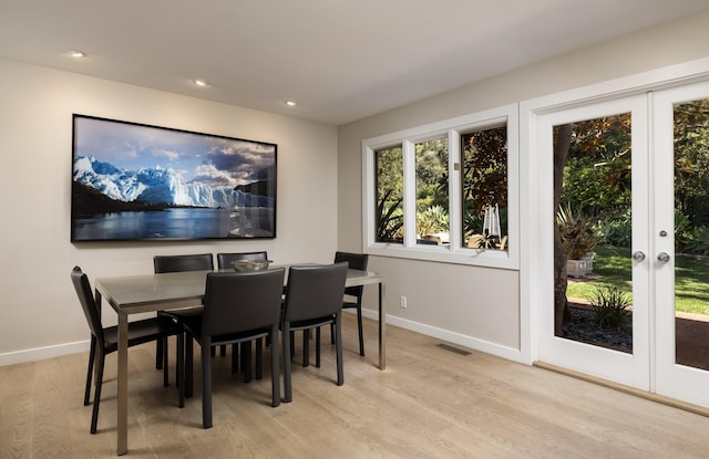 dining room featuring light hardwood / wood-style floors and french doors