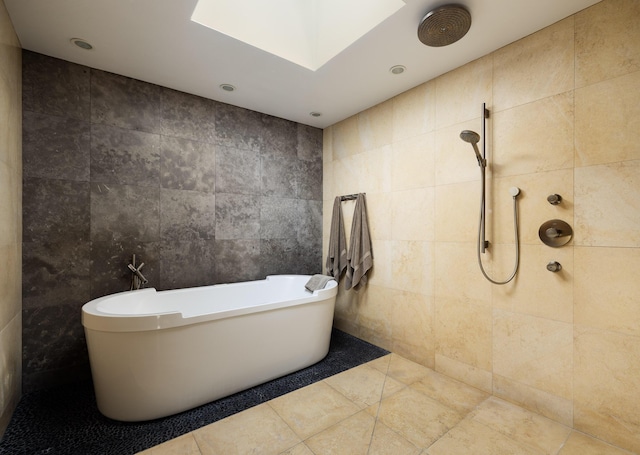 bathroom with tile walls and independent shower and bath