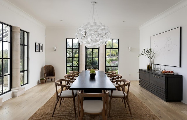 dining room with a chandelier, light hardwood / wood-style flooring, and crown molding