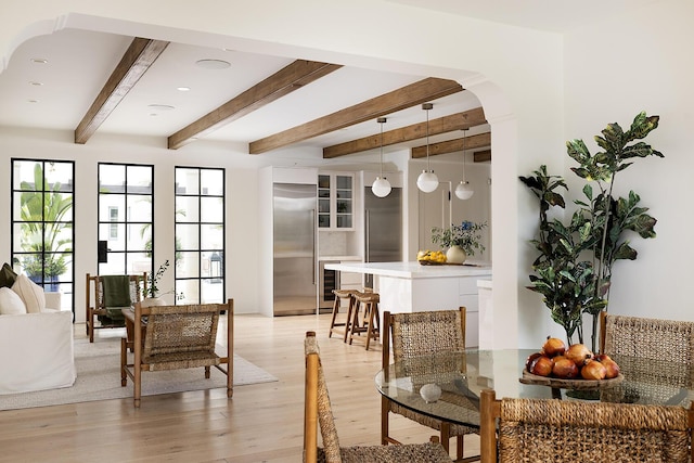 sitting room featuring beam ceiling and light hardwood / wood-style flooring