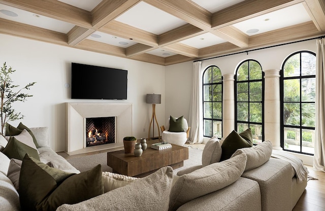 living room featuring beamed ceiling and coffered ceiling